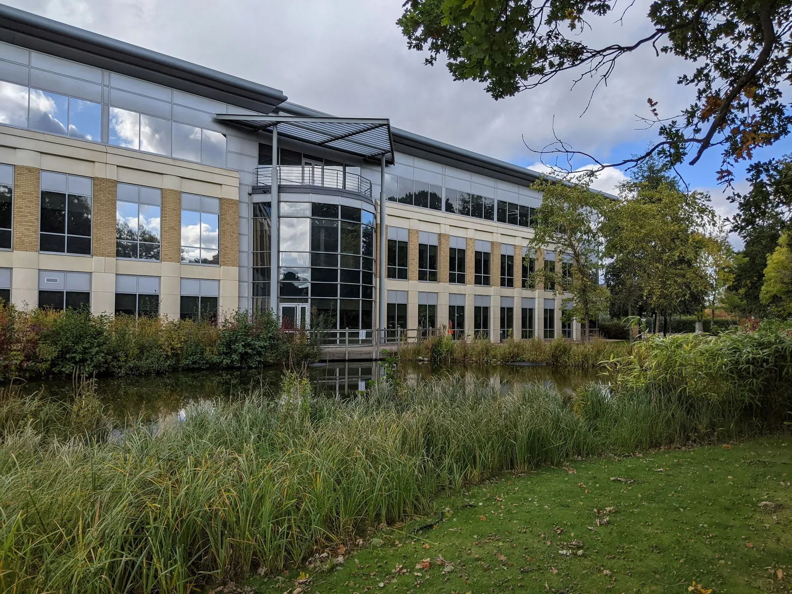 An office building beside a landscaped pond at Birmingham Business Park.